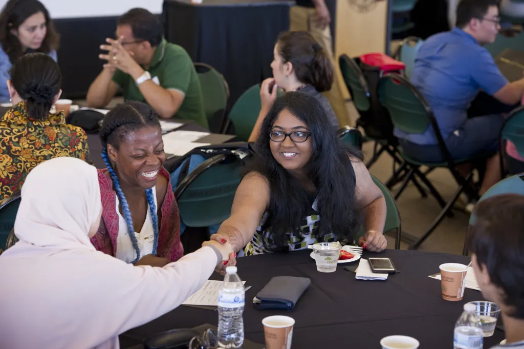 International students shaking hands at orientation