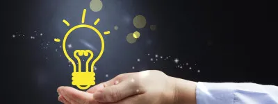 hand holding an illustrated light bulb