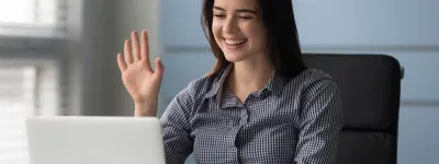 Person smiling in a virtual meeting