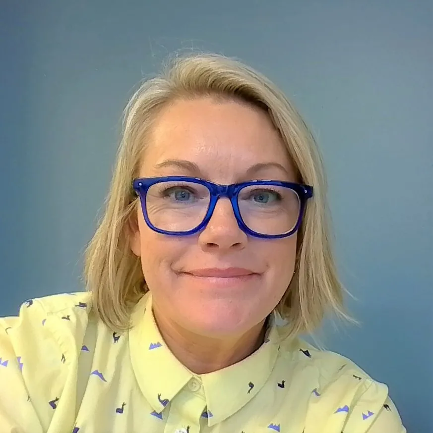 profile picture of Misty Evans, blonde hair, blue glasses, and yellow shirt